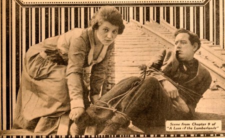 Helen Holmes lends a hand in "Lass of the Lumberlands"