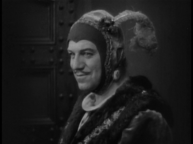 Montagu Love smiles, confident that he has won the silly hat contest.