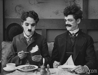 Chaplin chows down in "The Immigrant"