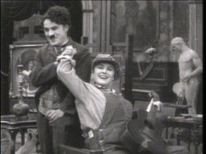 Chaplin and Purviance breaking character.