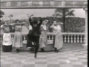 Chaplin leads the dance of the cleaning ladies.