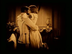 Norman Kerry’s roving hands.