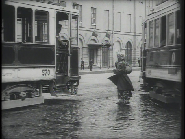 Masha arrives in the city. The scale of the shot illustrates her alienation.